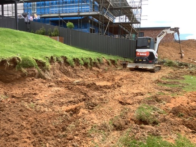 Concrete sleeper retaining wall beside an established lawn