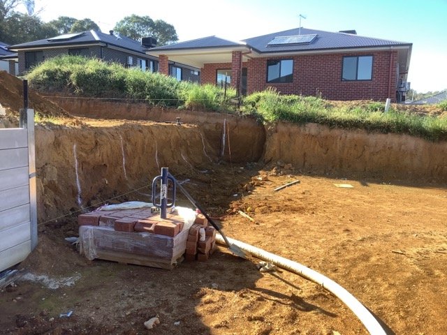 Excavated Thurgoona-style residential site prepared for a concrete sleeper retaining wall