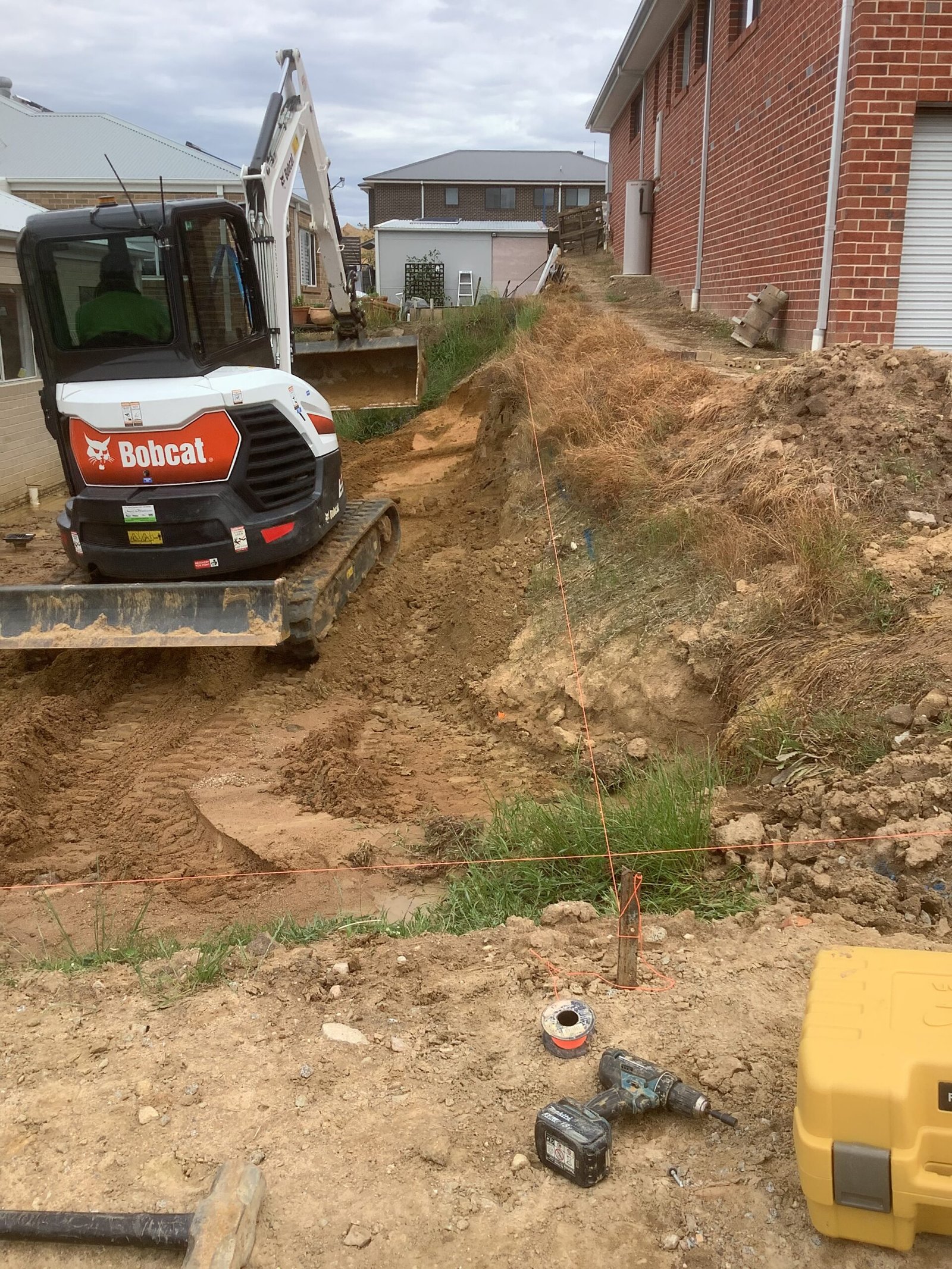 Excavation work beside a residential brick property
