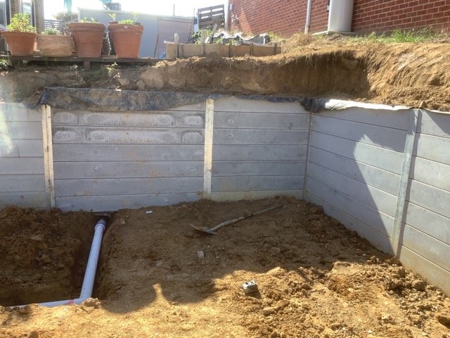 Earthworks surrounding a concrete sleeper retaining wall
