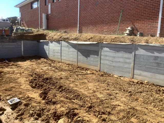 Concrete sleeper retaining wall and shaped residential ground