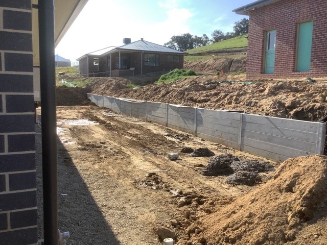 Concrete sleeper retaining wall and excavation beside a residential property