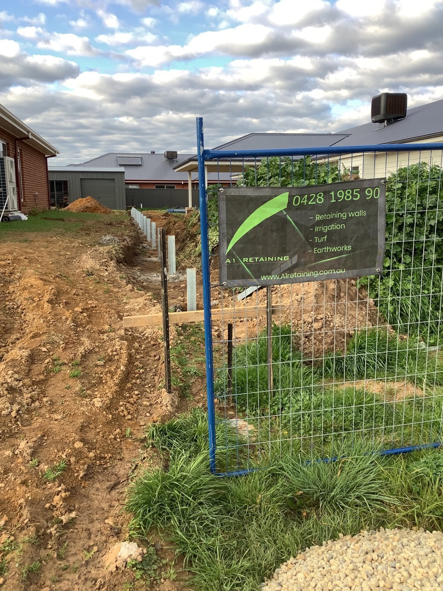 Concrete sleeper retaining wall posts during construction